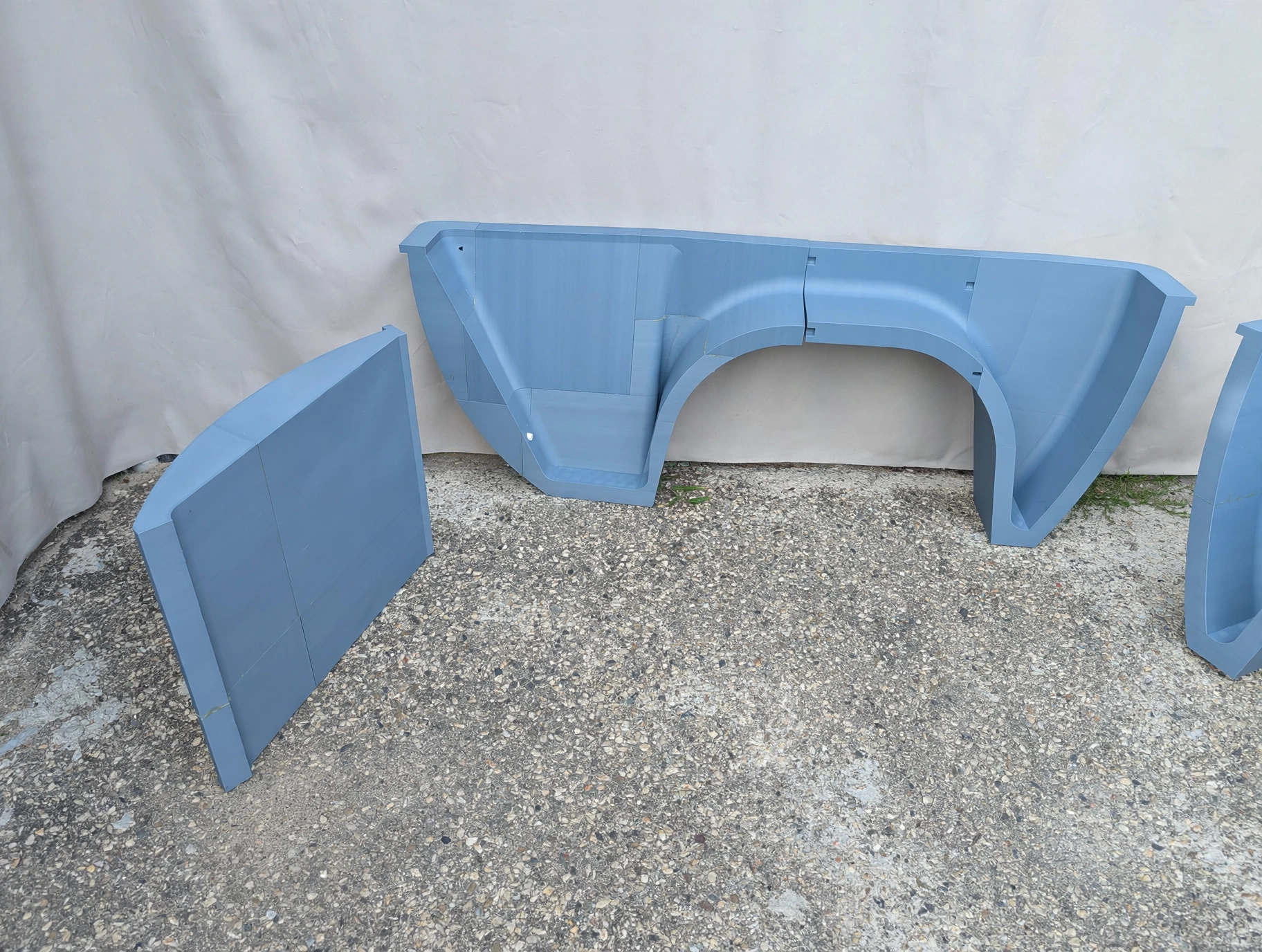 Printed motorcycle trailer fender sections and side panel laid out before assembly