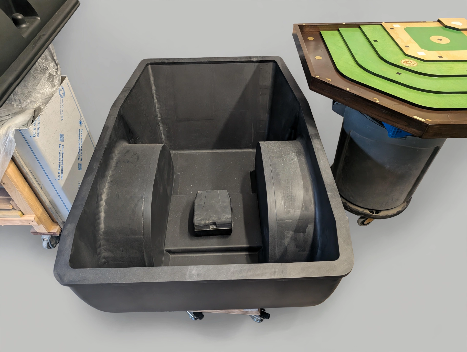 Motorcycle trailer tub interior after primer coating showing the wheel arches in matte black