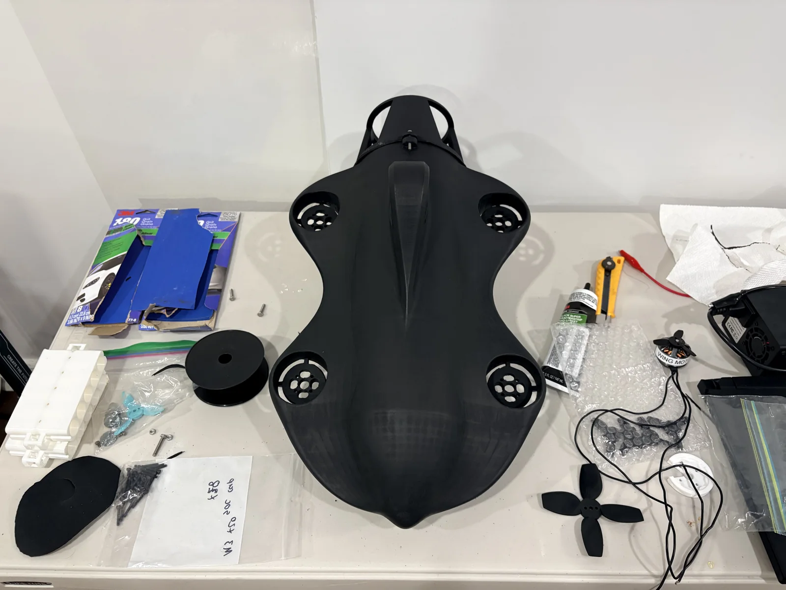 Pelagos Vantage V0 3D printed hull during assembly with thruster mounts, wiring and hardware
